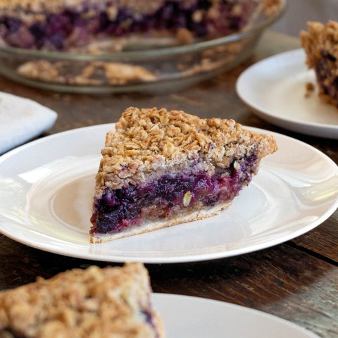 Slice of blueberry rhubarb pie with crumble topping from Four & Twenty Blackbirds.