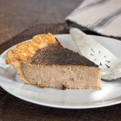 A slice of Dirty Chai Custard pie on a white plate. 